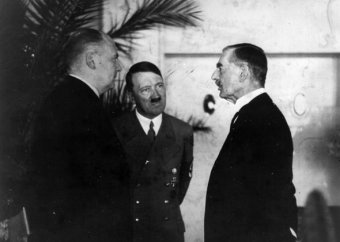 Hitler's interpreter Paul Schmidt conveying the Fuhrer's respond to a question from Neville Chamberlain during their meeting at the resort Dreesen at Godesberg.,96d/26/inns/4433/15